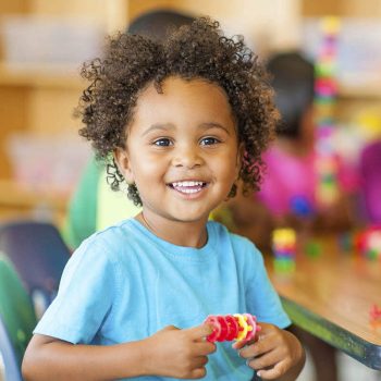 Smiling boy with toy
