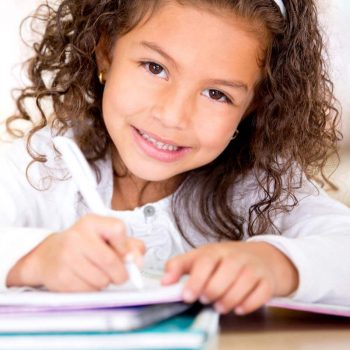 Little girl writing in notebook